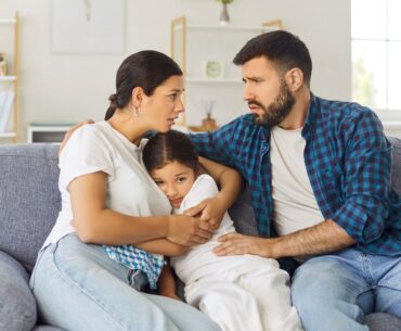 Parents hugging child during crisis