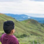 Child looking at mountainous scenery