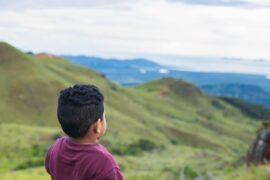 Child looking at mountainous scenery