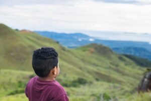 Child looking at mountainous scenery