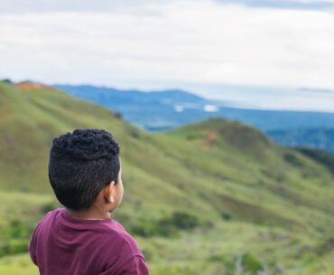 Child looking at mountainous scenery
