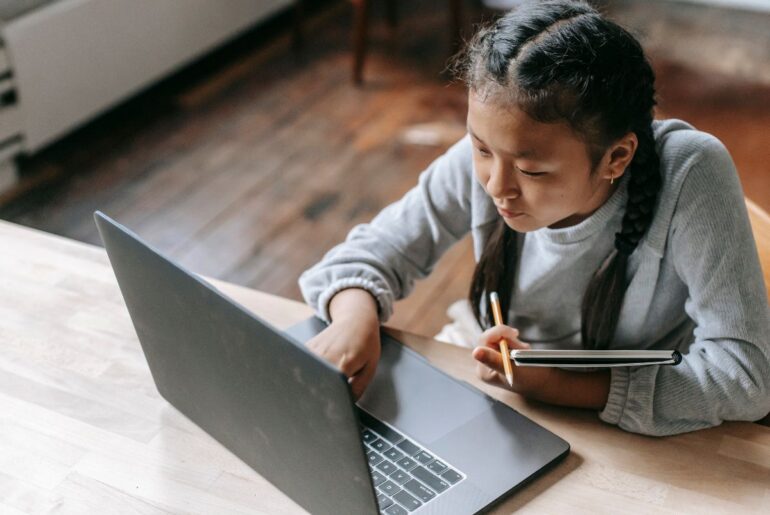 6 books that help kids learn to spot misinformation Kid using critical thinking skills online