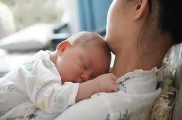 Hospitals say they found a tool to help reduce childbirth risks: wristbands Mother holding newborn baby