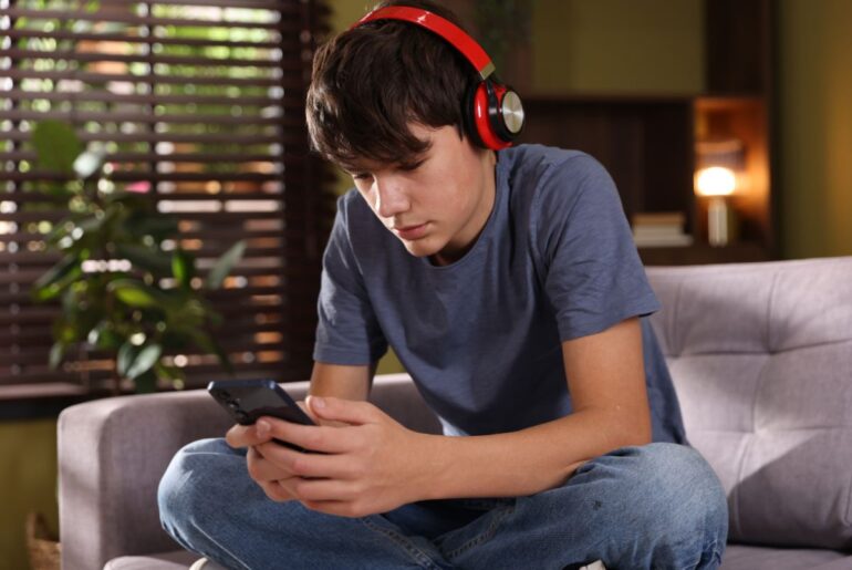 Teen boy looking at phone