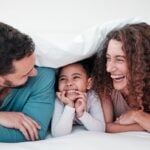 Parents laughing and talking with child