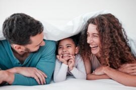Parents laughing and talking with child
