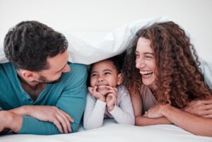 Parents laughing and talking with child
