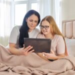 Teen and mom looking at tablet together