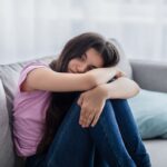 Depressed teen on couch