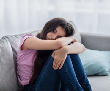 Depressed teen on couch