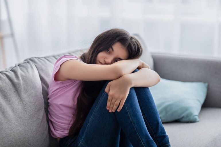 Students say mental health isn’t taboo — but talking to parents is Depressed teen on couch