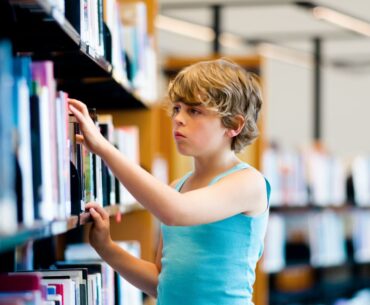 Kid browsing library shelves